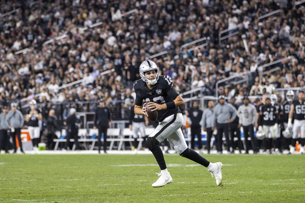 Raiders quarterback Aidan O'Connell (12) looks to pass the ball during the second half of the N ...