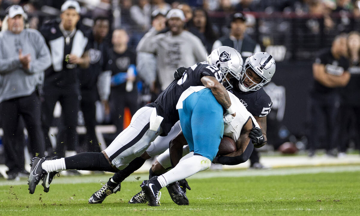 Raiders cornerback Decamerion Richardson (25) and linebacker Amari Burney, right, tackle Jackso ...