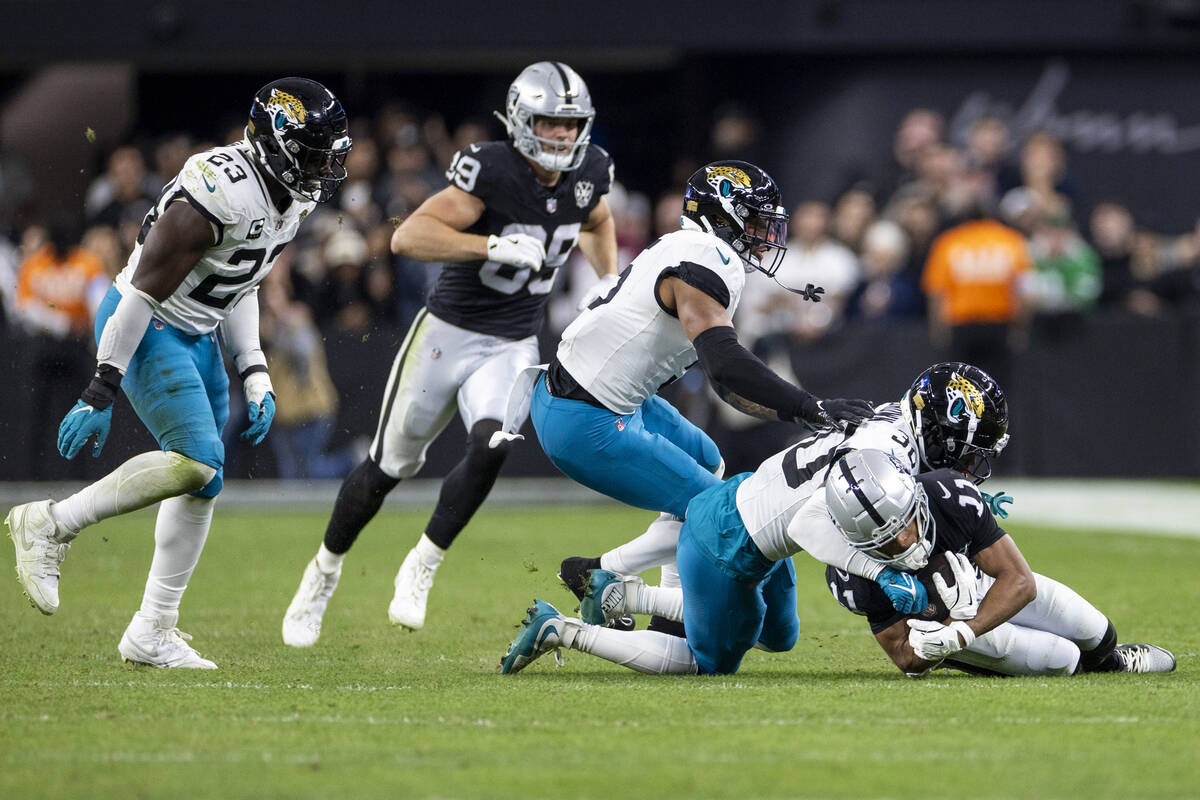 Raiders wide receiver Tre Tucker (11) is tackled by Jacksonville Jaguars cornerback Montaric Br ...