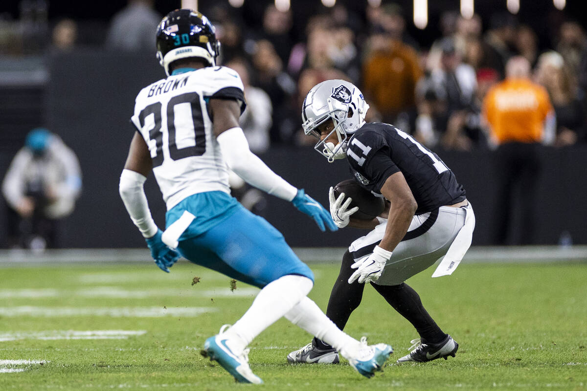 Raiders wide receiver Tre Tucker (11) turns to run toward Jacksonville Jaguars cornerback Monta ...