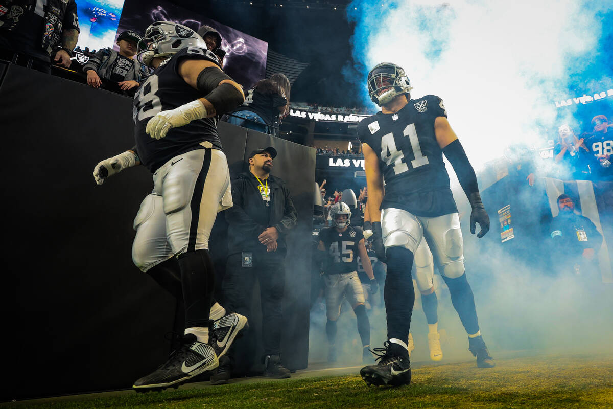 Raiders linebacker Robert Spillane (41) pumps himself up as he enters the field before an NFL f ...