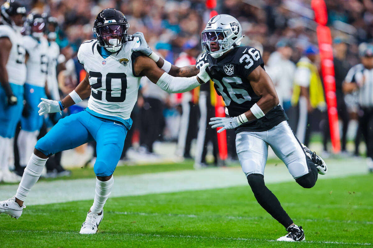 Jacksonville Jaguars safety Daniel Thomas (20) and Raiders cornerback Kyu Blu Kelly (36) push o ...