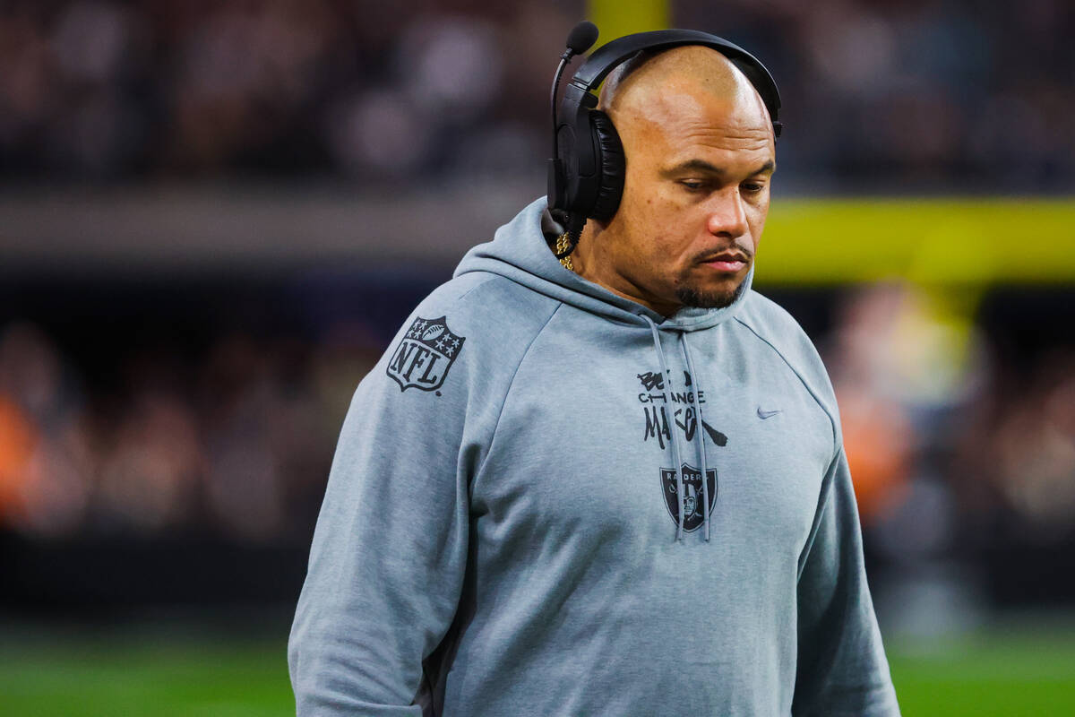 Raiders head coach Antonio Pierce walks the sidelines during an NFL football game between the R ...