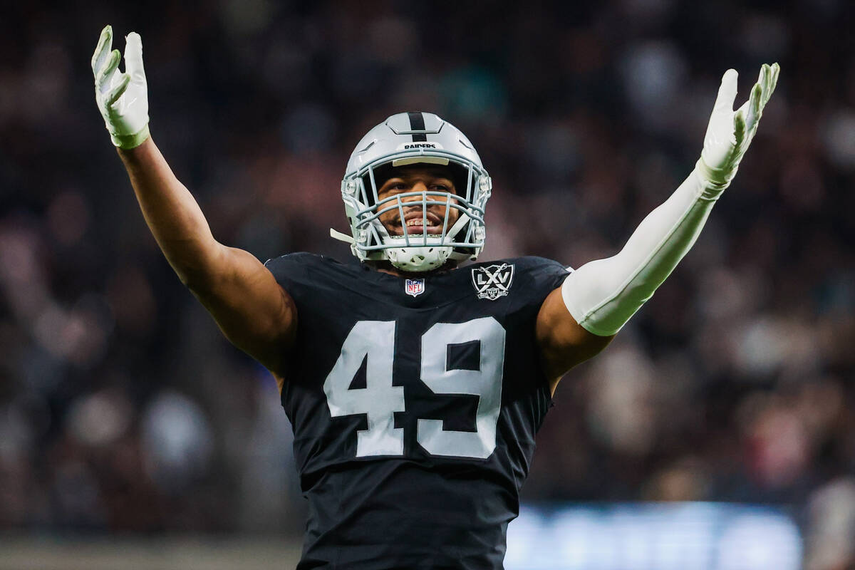 Raiders defensive end Charles Snowden (49) pumps up the crowd during an NFL football game betwe ...