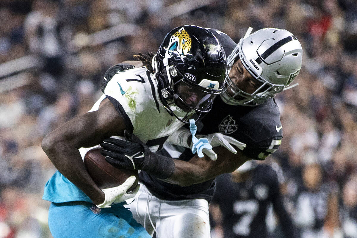 Raiders linebacker Divine Deablo, right, attempts to tackle Jacksonville Jaguars wide receiver ...