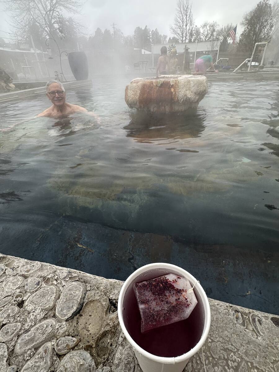 A look at a cup of raspberry tea, with Lava Hot Springs Inn owner George Katsilometes in the ba ...