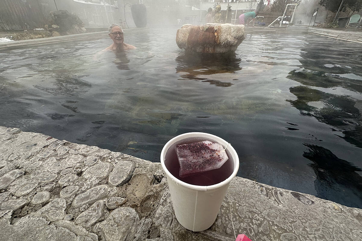 A look at a cup of raspberry tea, with Lava Hot Springs Inn owner George Katsilometes in the ba ...