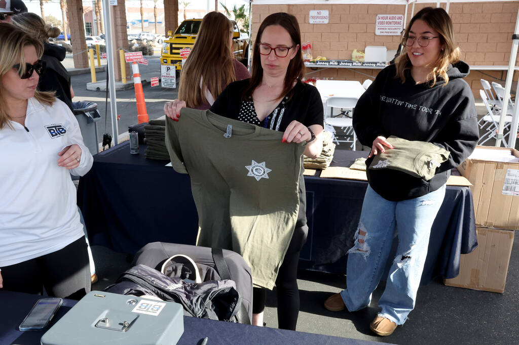 Kimberly Owensby, from left, Deborah Huff and Rachel Kutsunai sell T-shirts during a Behin ...