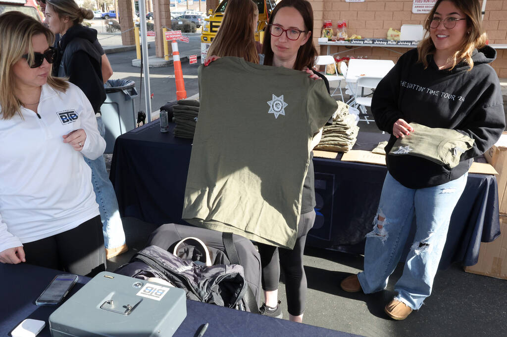 Kimberly Owensby, from left, Deborah Huff and Rachel Kutsunai sell T-shirts during a Behin ...