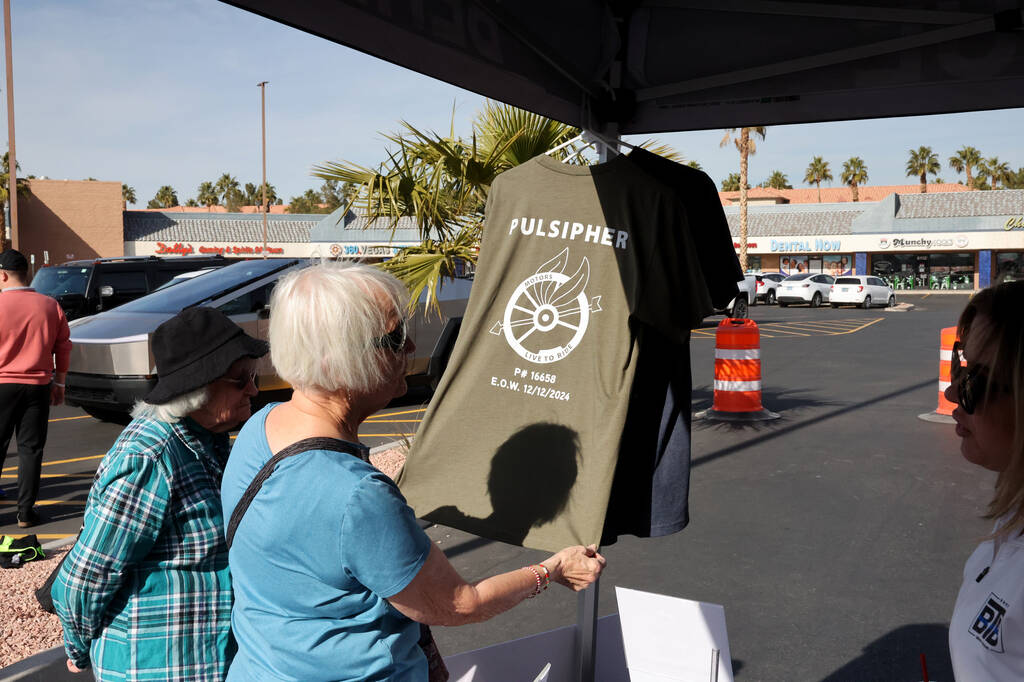 Candice Leigh buys a T-shirt honoring Metropolitan Police Department officer Colton Pulsipher d ...