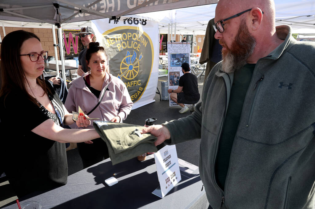 Retired Las Vegas police officer Brandon Eager buys a T-shirt honoring Metropolitan Police Depa ...