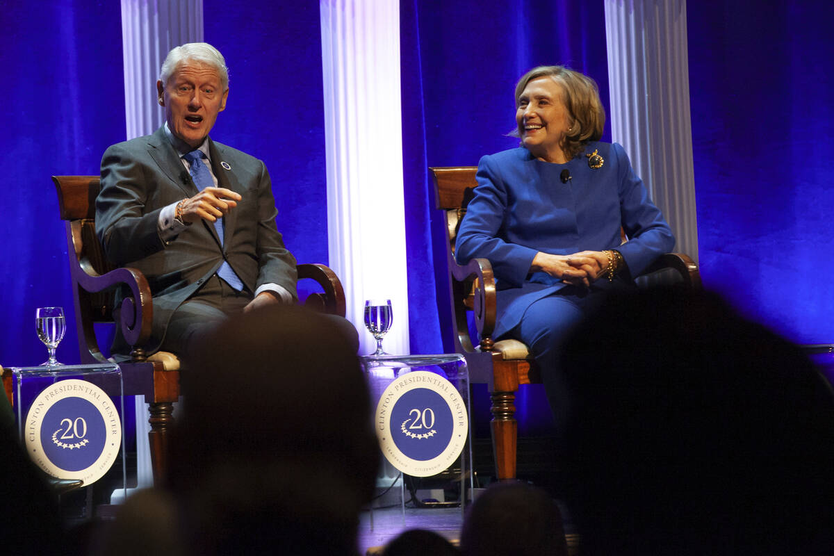 Former President Bill Clinton and former Secretary of State Hillary Rodham Clinton respond to a ...