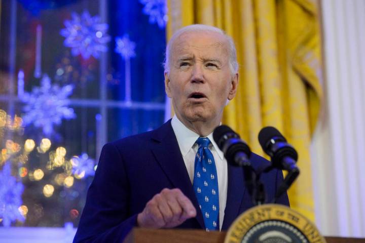 President Joe Biden speaks during a Hanukkah reception in the East Room of the White House in W ...