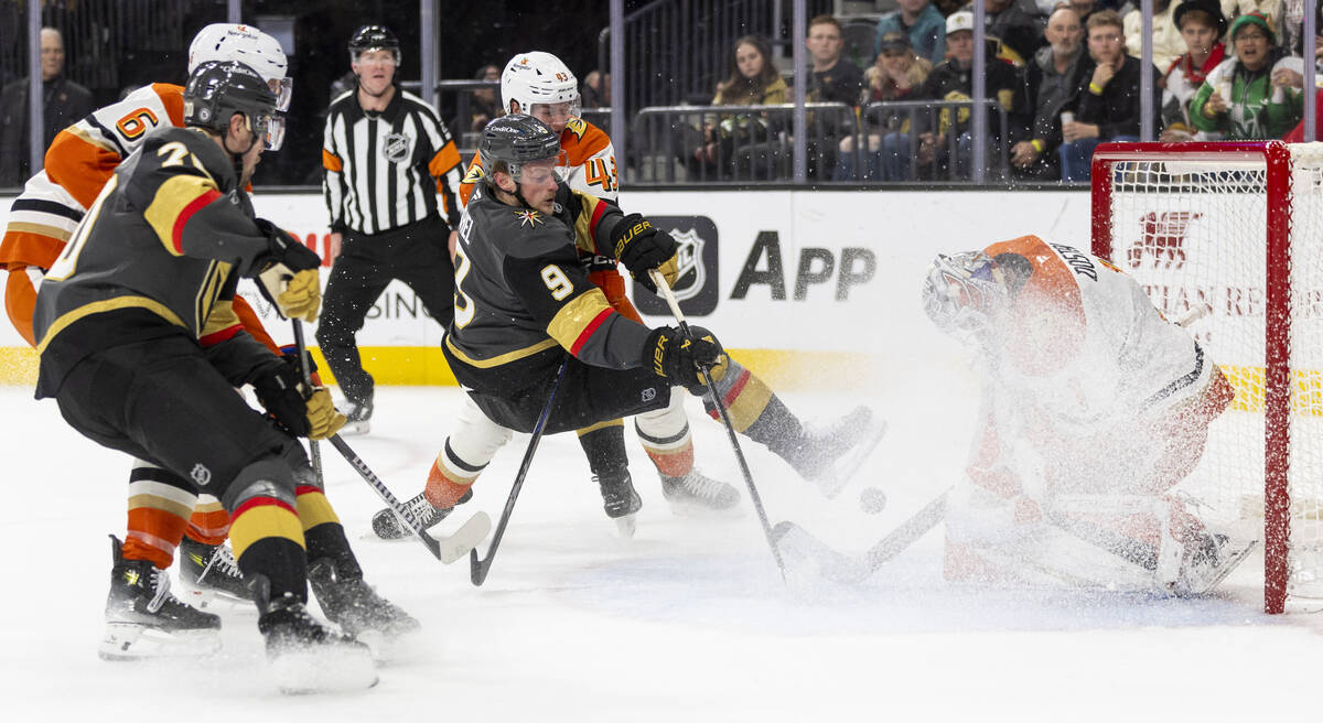 Golden Knights center Jack Eichel (9) falls while attempting a shot during the third period of ...