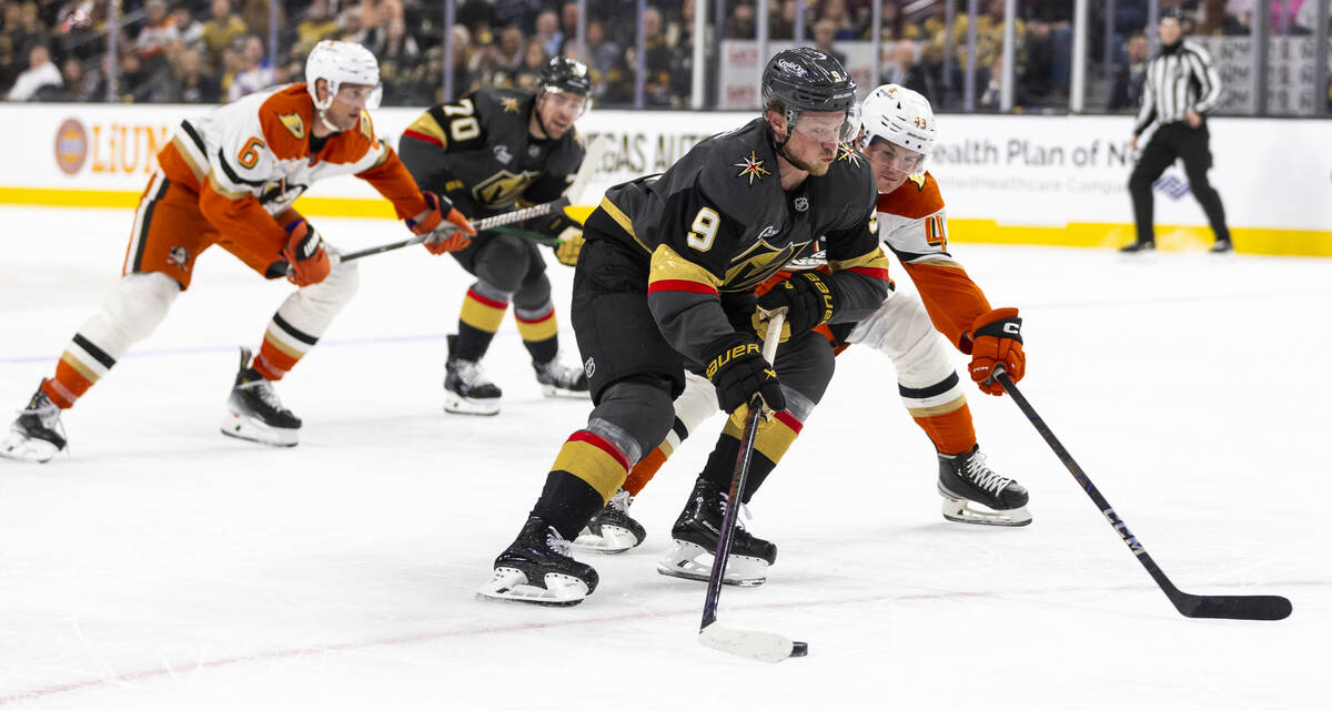 Golden Knights center Jack Eichel (9) skates around Anaheim Ducks defenseman Drew Helleson (43) ...