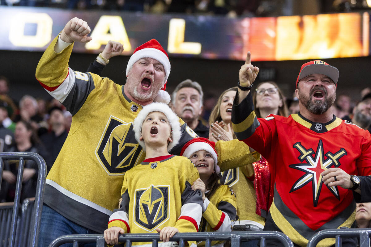 Golden Knights fans cheer after a goal is scored during the third period of the NHL hockey game ...