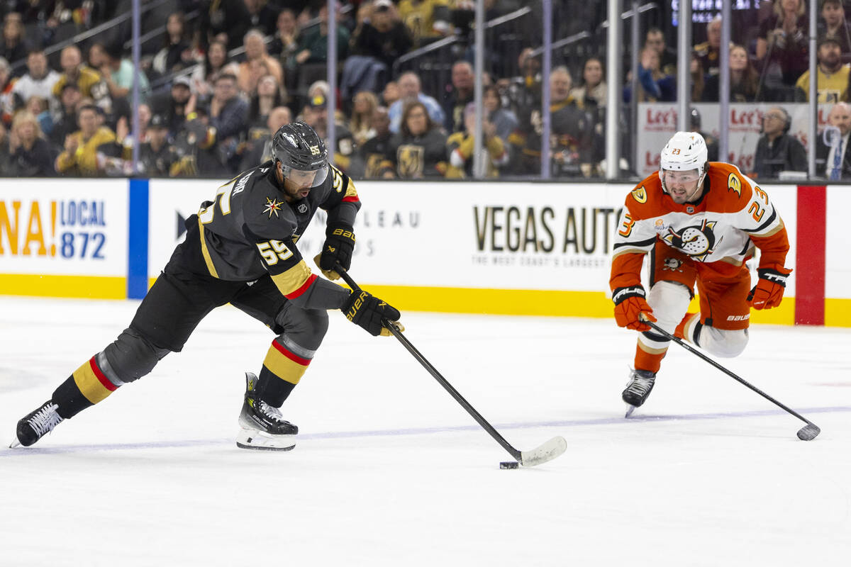 Golden Knights right wing Keegan Kolesar (55) avoids Anaheim Ducks center Mason McTavish (23) d ...