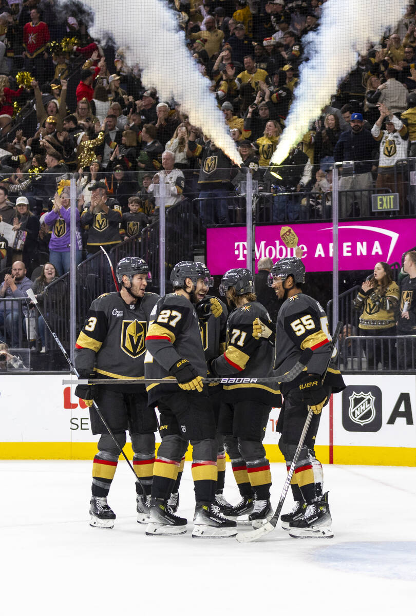 Golden Knights players celebrate a goal during the third period of the NHL hockey game against ...