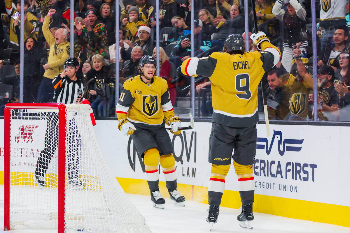 Golden Knights center Brett Howden (21) and Golden Knights center Jack Eichel (9) celebrate a g ...