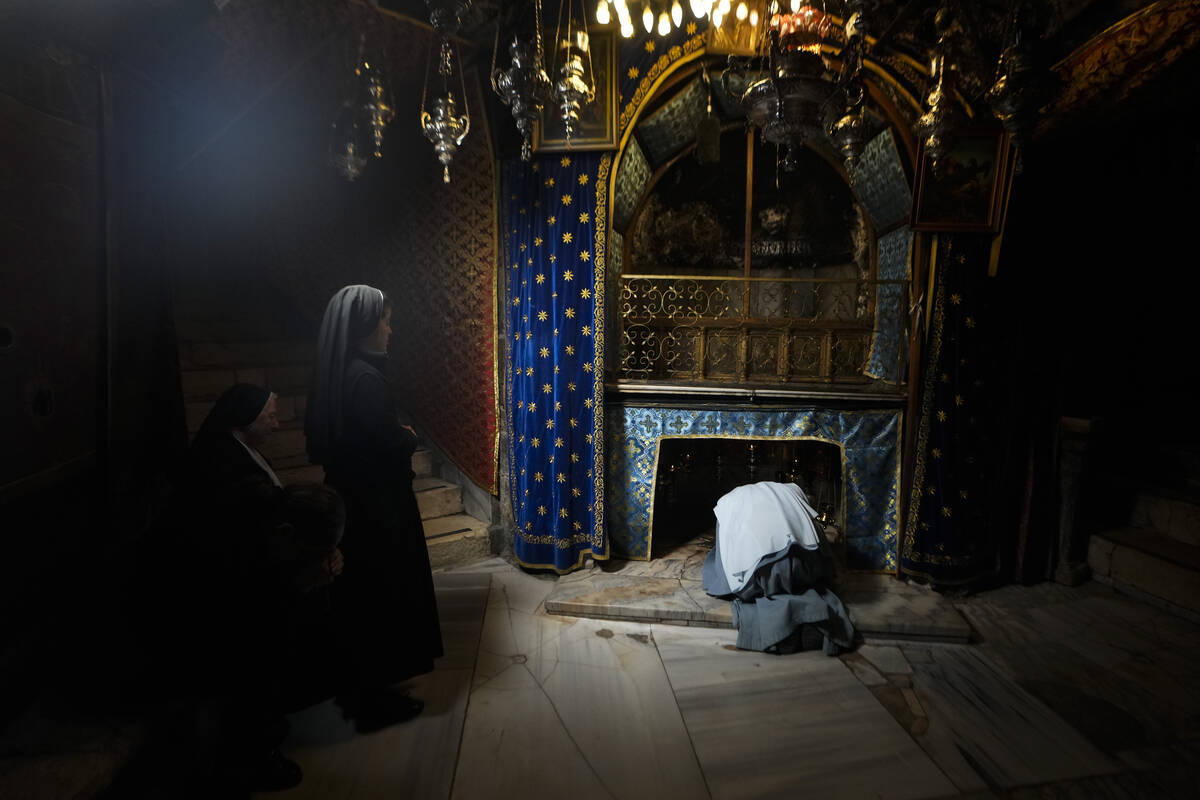 Worshippers pray at the Church of the Nativity, traditionally believed to be the birthplace of ...