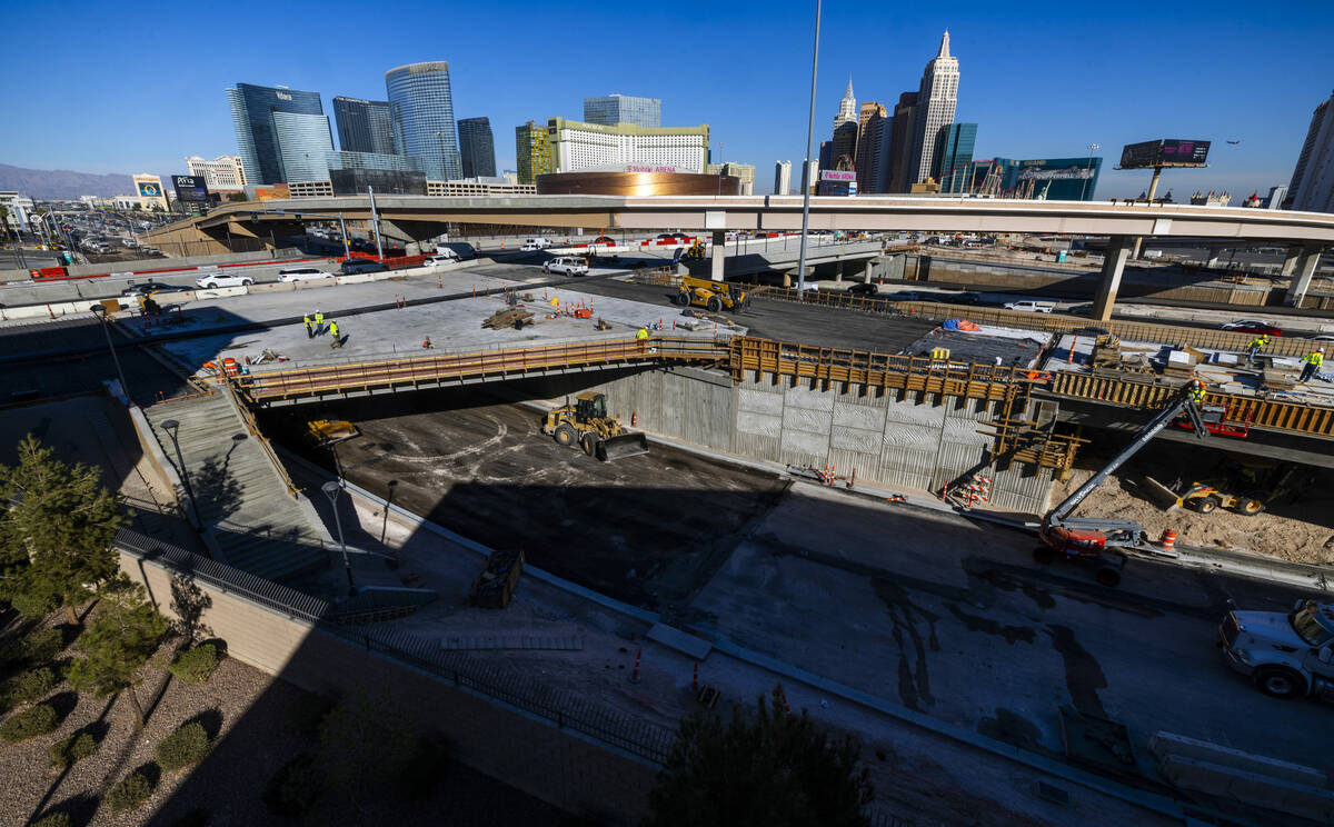 A crew continues to work on the bridge southbound from Tropicana Avenue onto the I-15 and other ...