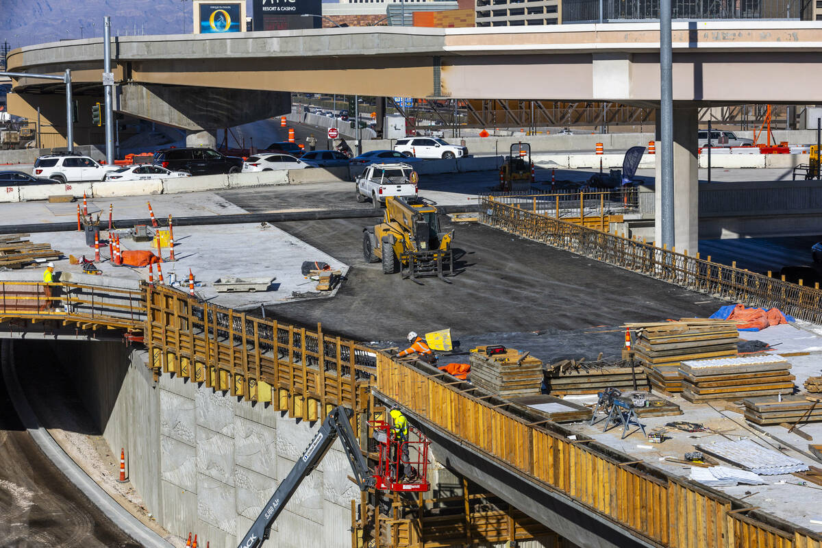 A crew continues to work on the bridge southbound from Tropicana Avenue onto the I-15 and other ...