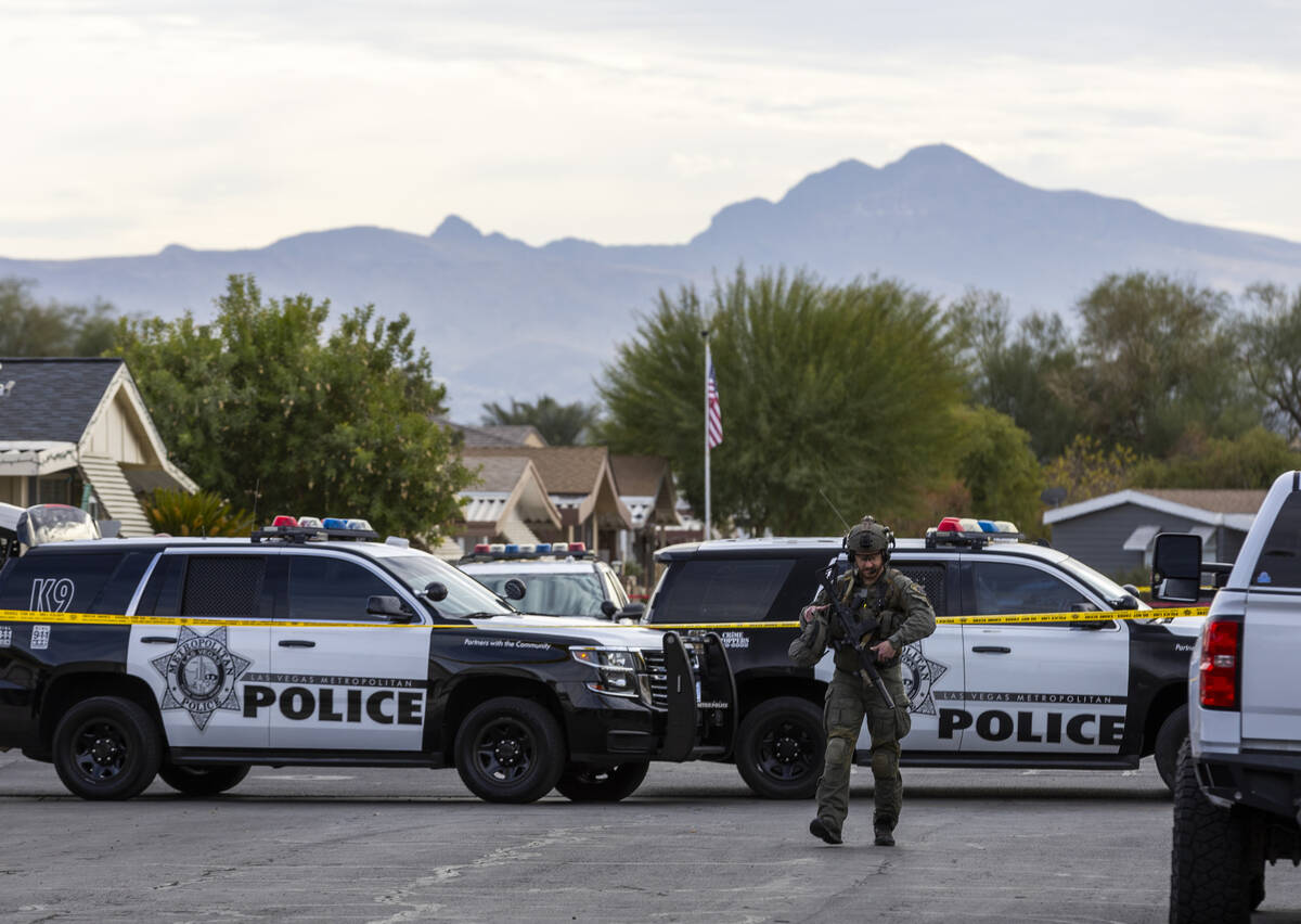 A SWAT officer walks down the street as the Metropolitan Police Department takea a barricaded s ...