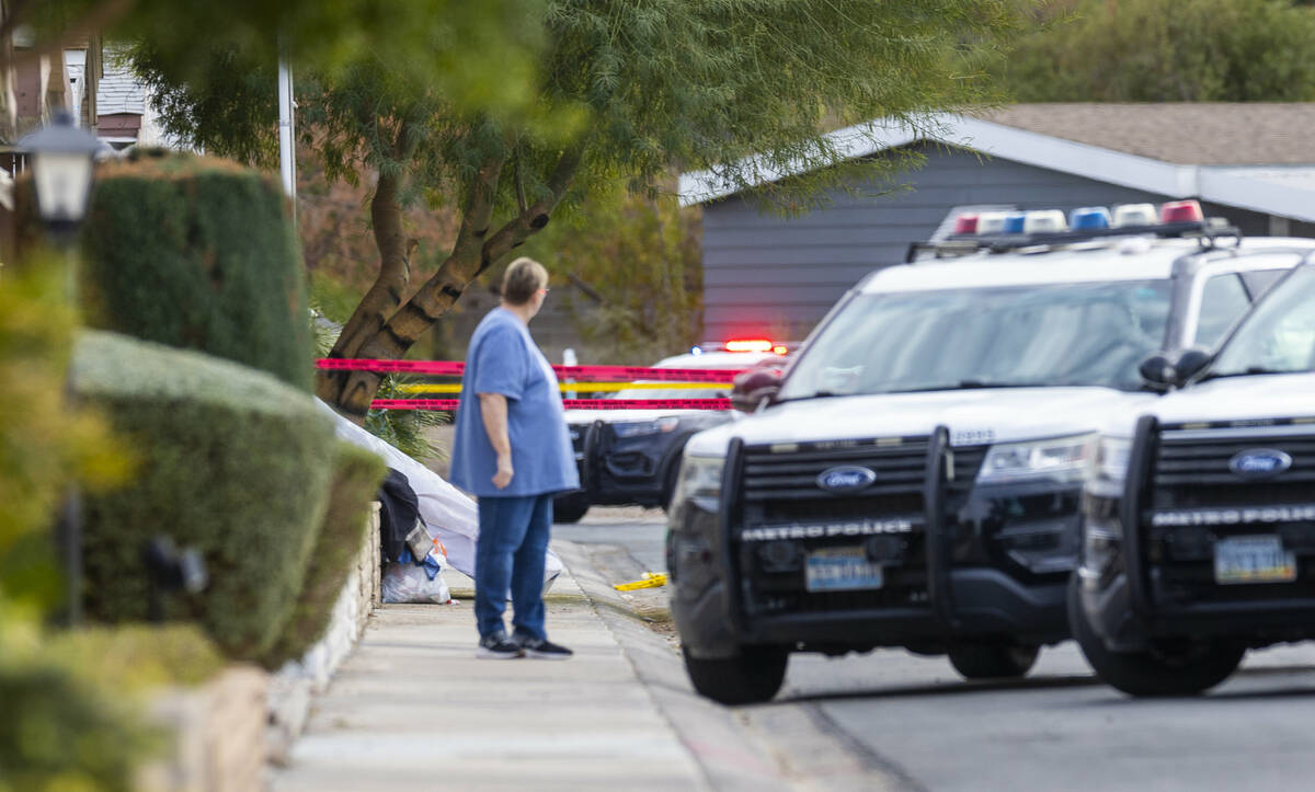 A mattress and clothes are tossed on the street as Metropolitan Police Department officers take ...