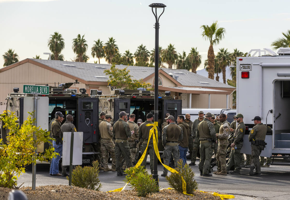 Personnel wrap up operations after the Metropolitan Police Department take a barricaded suspect ...