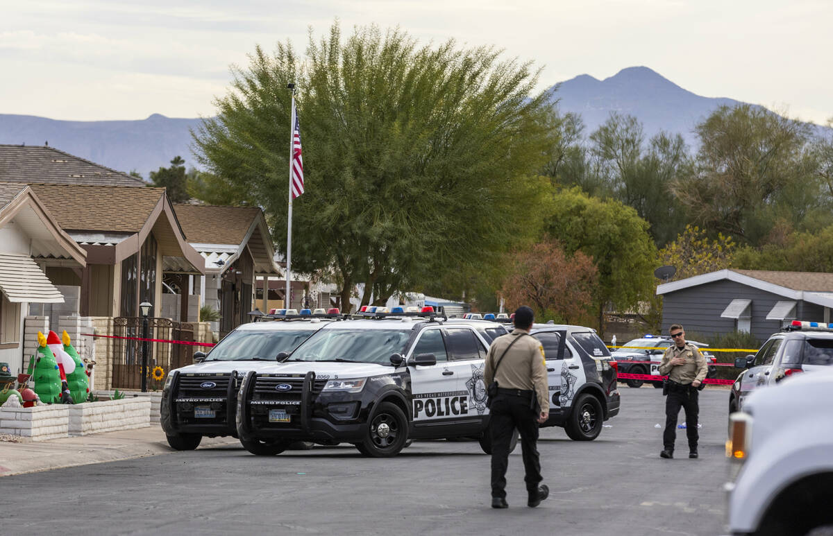 Metropolitan Police Department officers gather around a residence as they take a barricaded sus ...