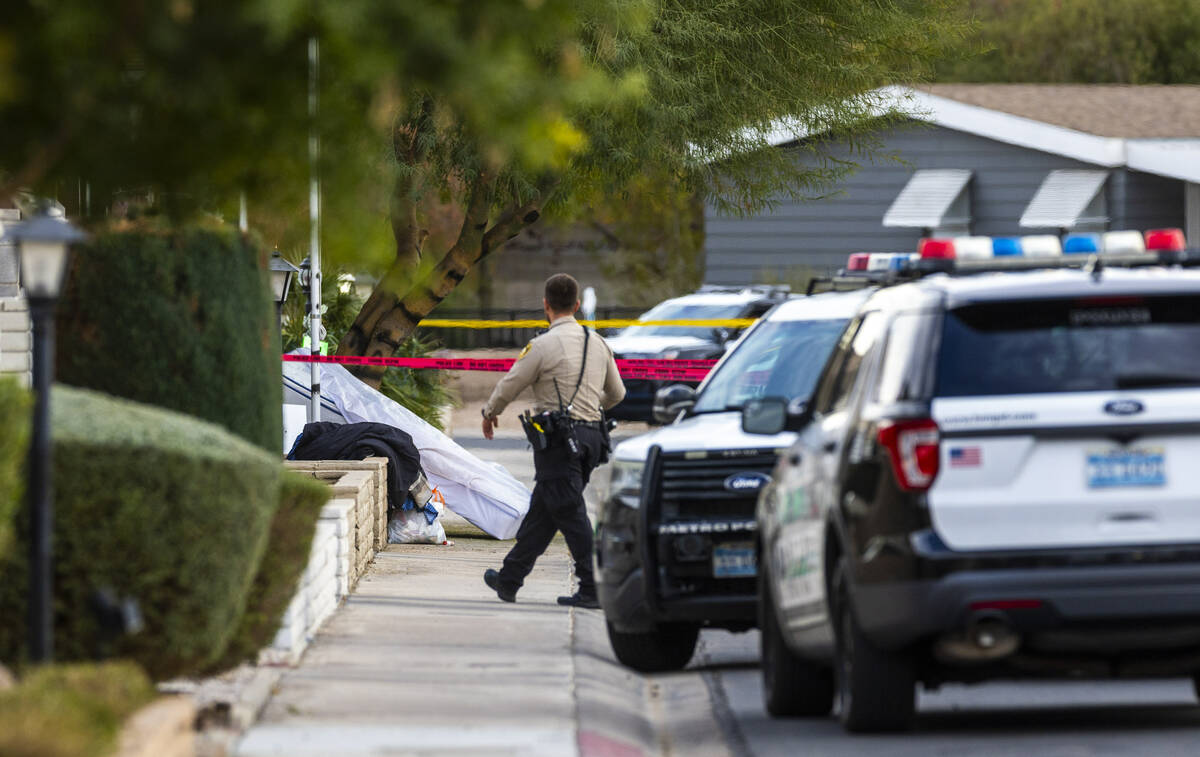 A mattress and clothes are tossed on the street as Metropolitan Police Department officers take ...