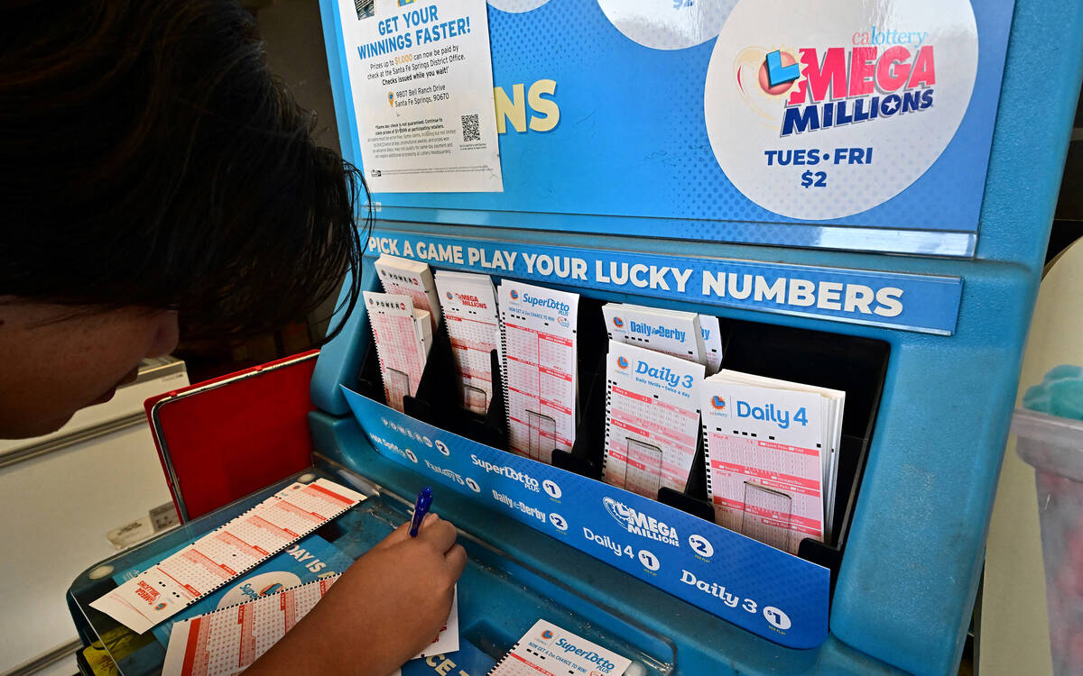 Numbers on tickets for the Mega Millions lottery are selected by a purchaser in Los Angeles, in ...