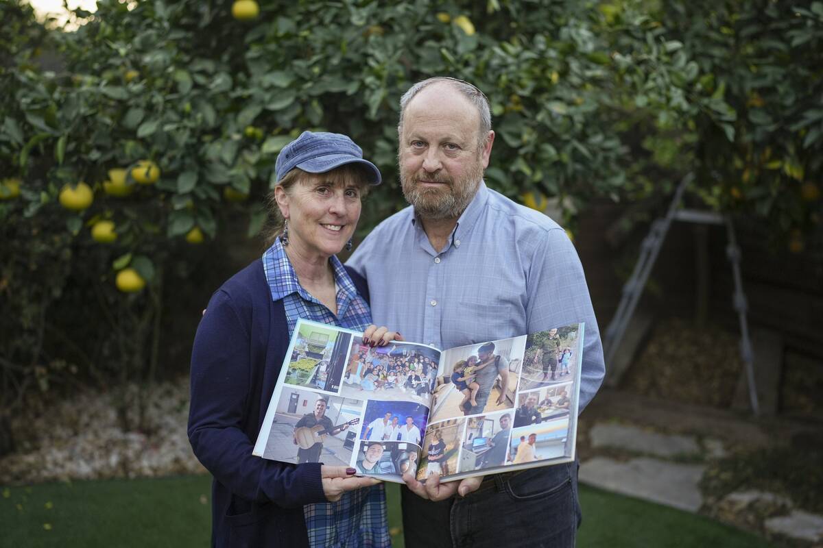 Hazel and David Brief hold a photo book made by their son Yona Brief who died 14 months after H ...