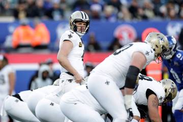 New Orleans Saints quarterback Derek Carr (4) at the line of scrimmage during an NFL football g ...