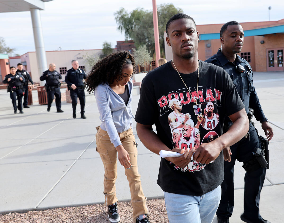 An unidentified man is escorted out of North Las Vegas Justice Court after he got into an alter ...