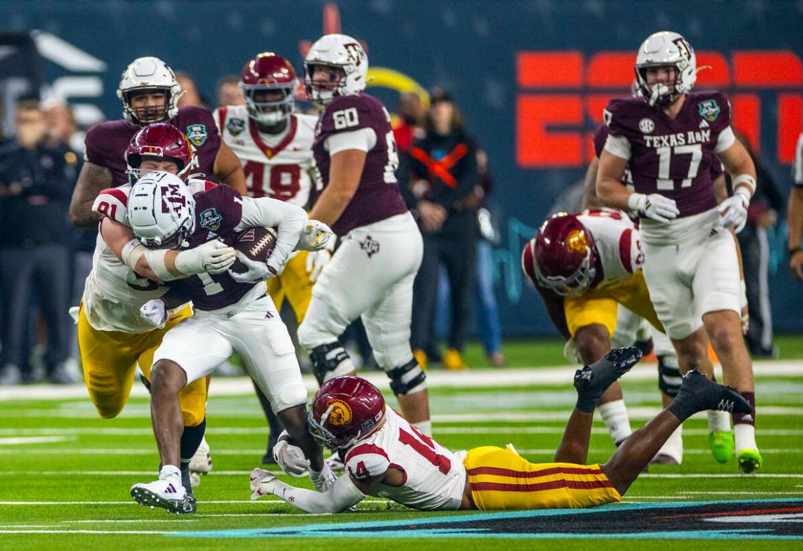 Texas A&M Aggies wide receiver Jabre Barber (1) battles for yards as USC Trojans defensive ...