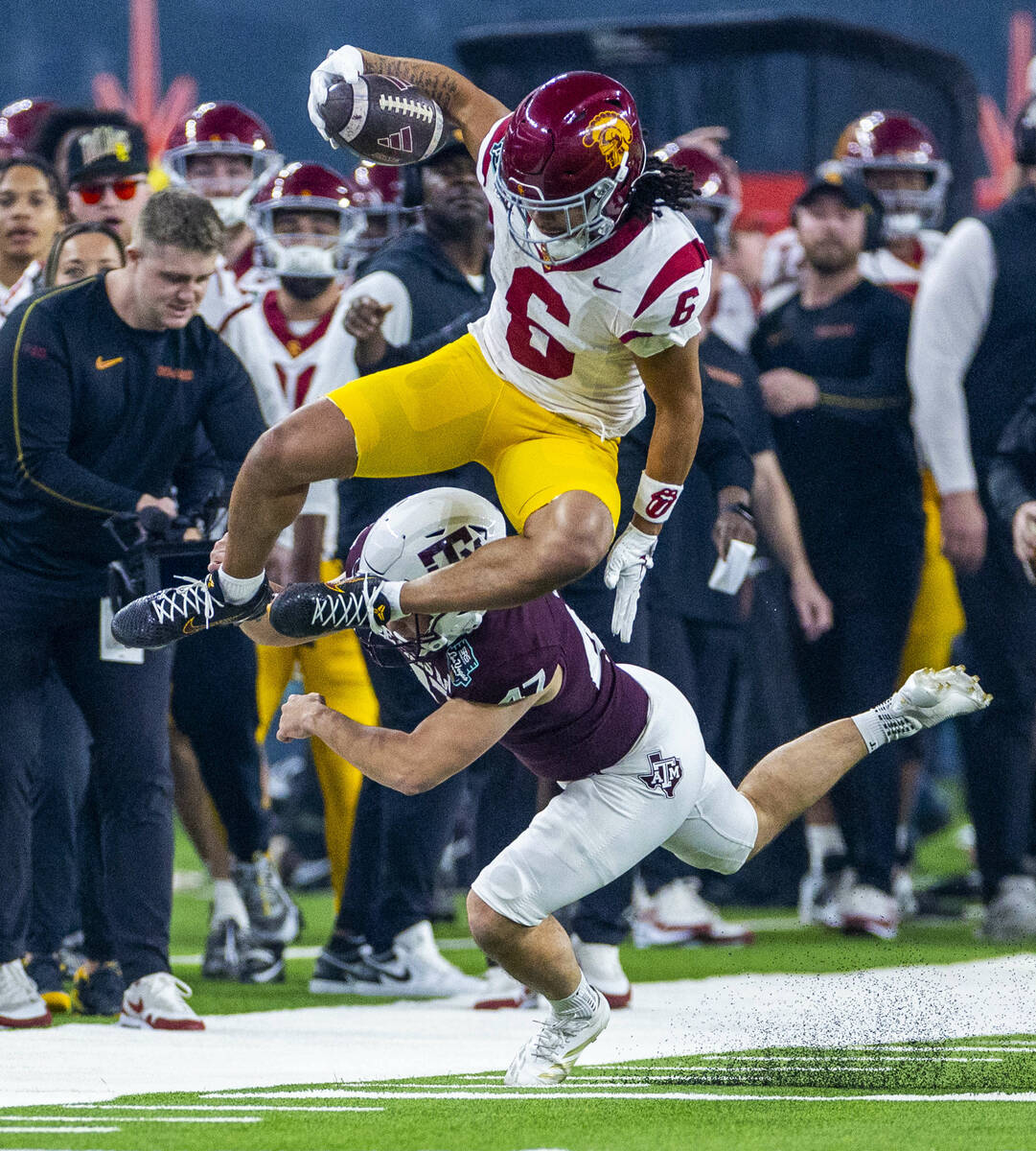 USC Trojans wide receiver Makai Lemon (6) leaps over Texas A&M Aggies place kicker Randy Bo ...