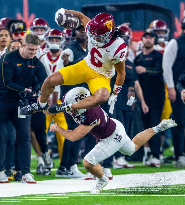 USC Trojans wide receiver Makai Lemon (6) leaps over Texas A&M Aggies place kicker Randy Bo ...