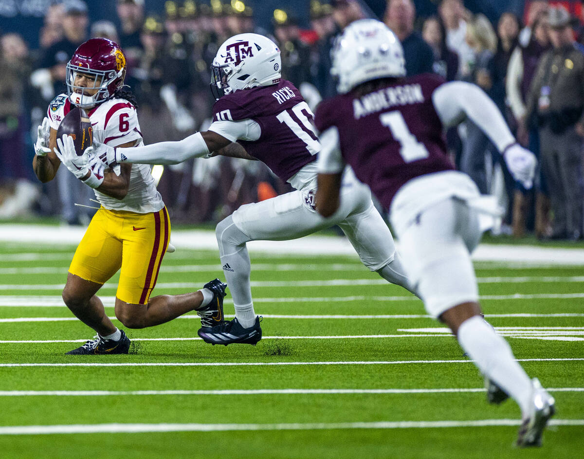 USC Trojans wide receiver Makai Lemon (6) looks to secure a pass as Texas A&M Aggies defens ...