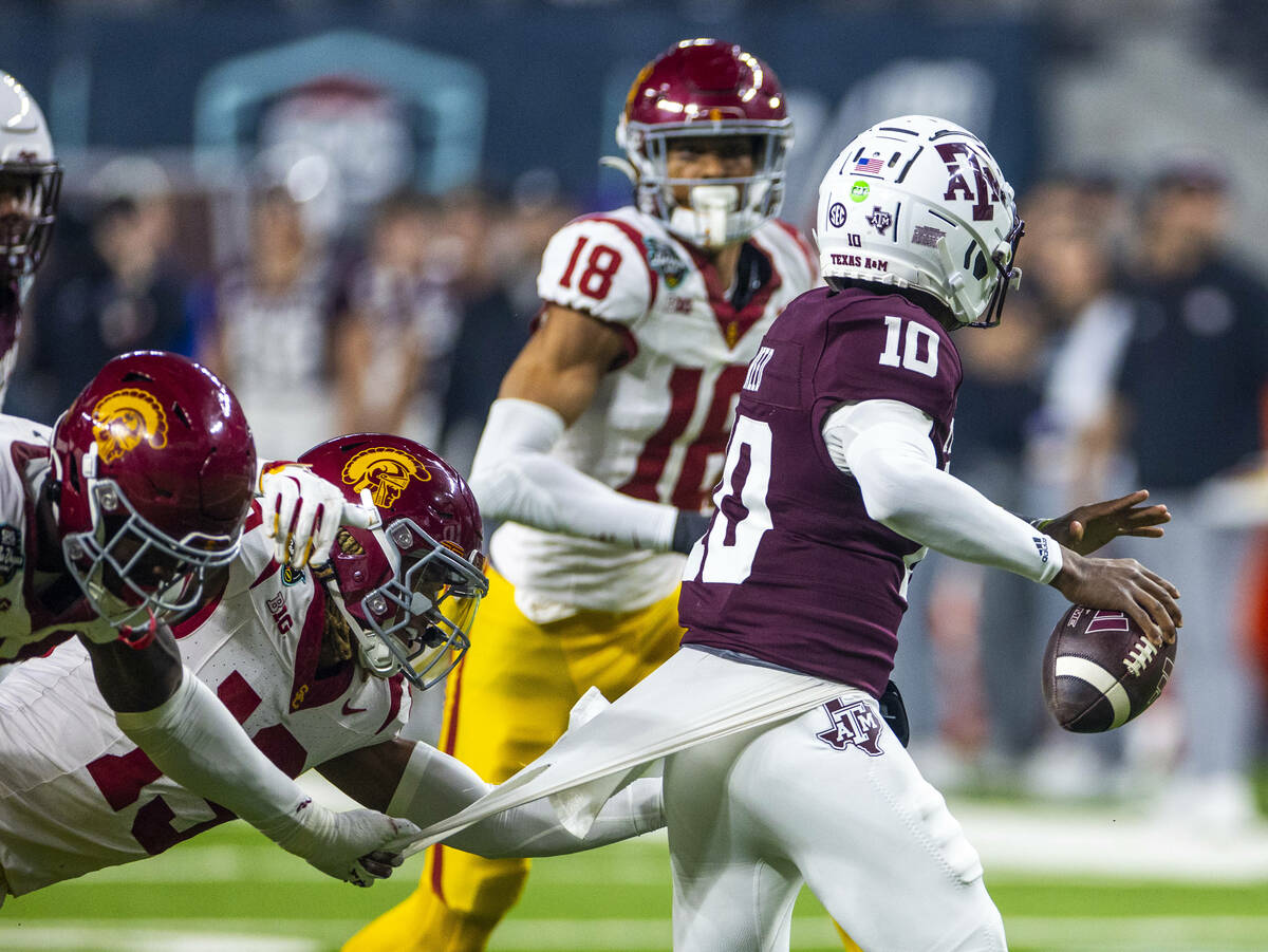 Texas A&M Aggies quarterback Marcel Reed (10) looks to pass as USC Trojans cornerback John ...