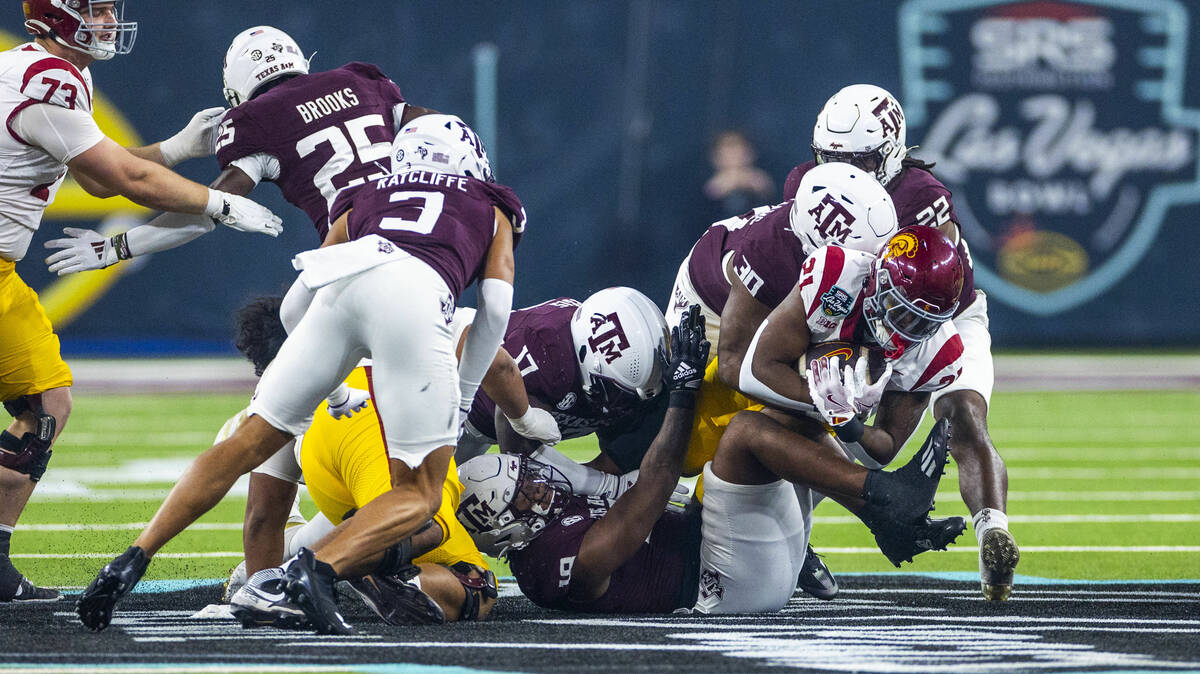 USC Trojans running back Bryan Jackson (21) is taken down on a run by Texas A&M Aggies defe ...