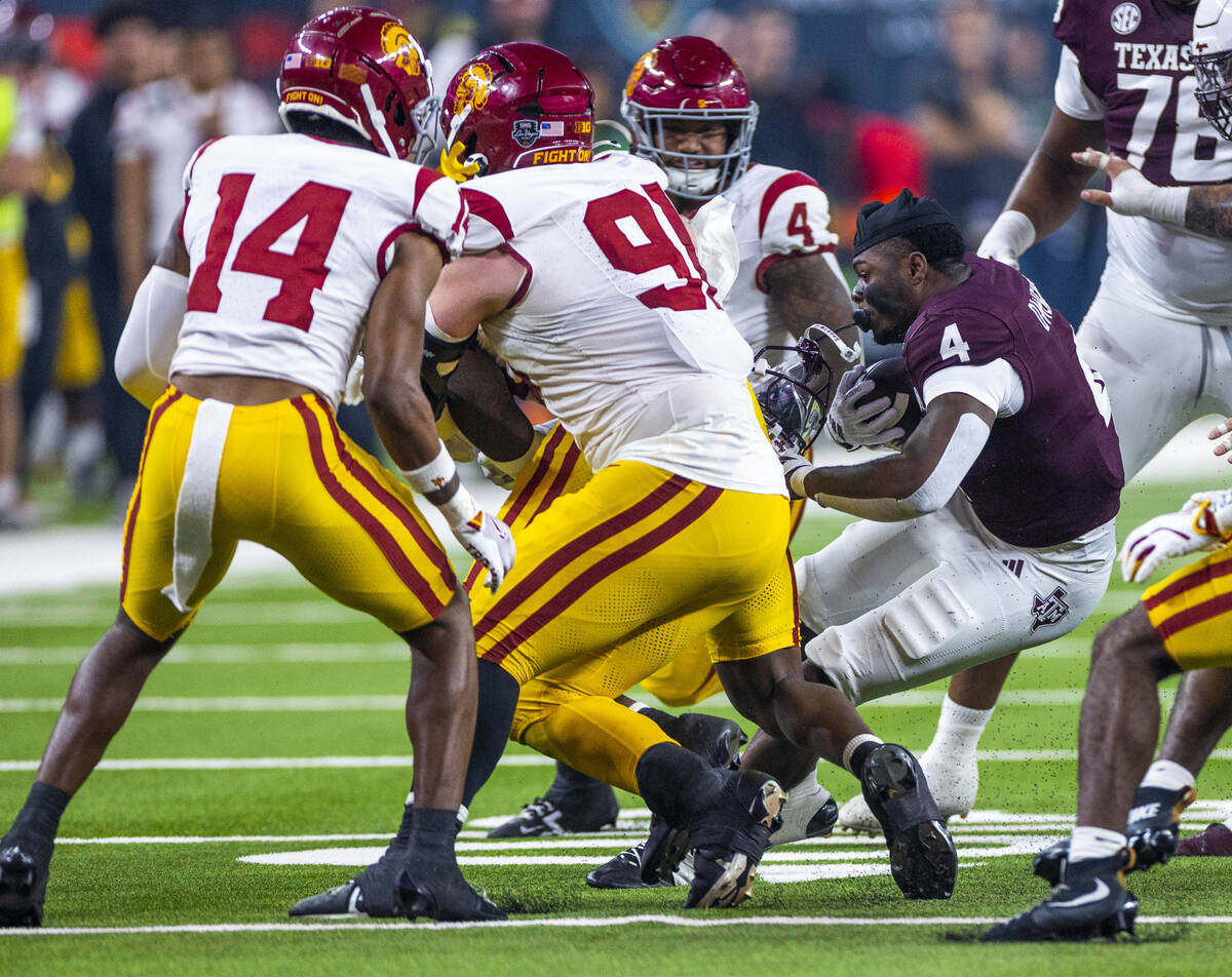 Texas A&M Aggies wide receiver Micah Tease (4) loses his helmet on a run after a hit by USC ...