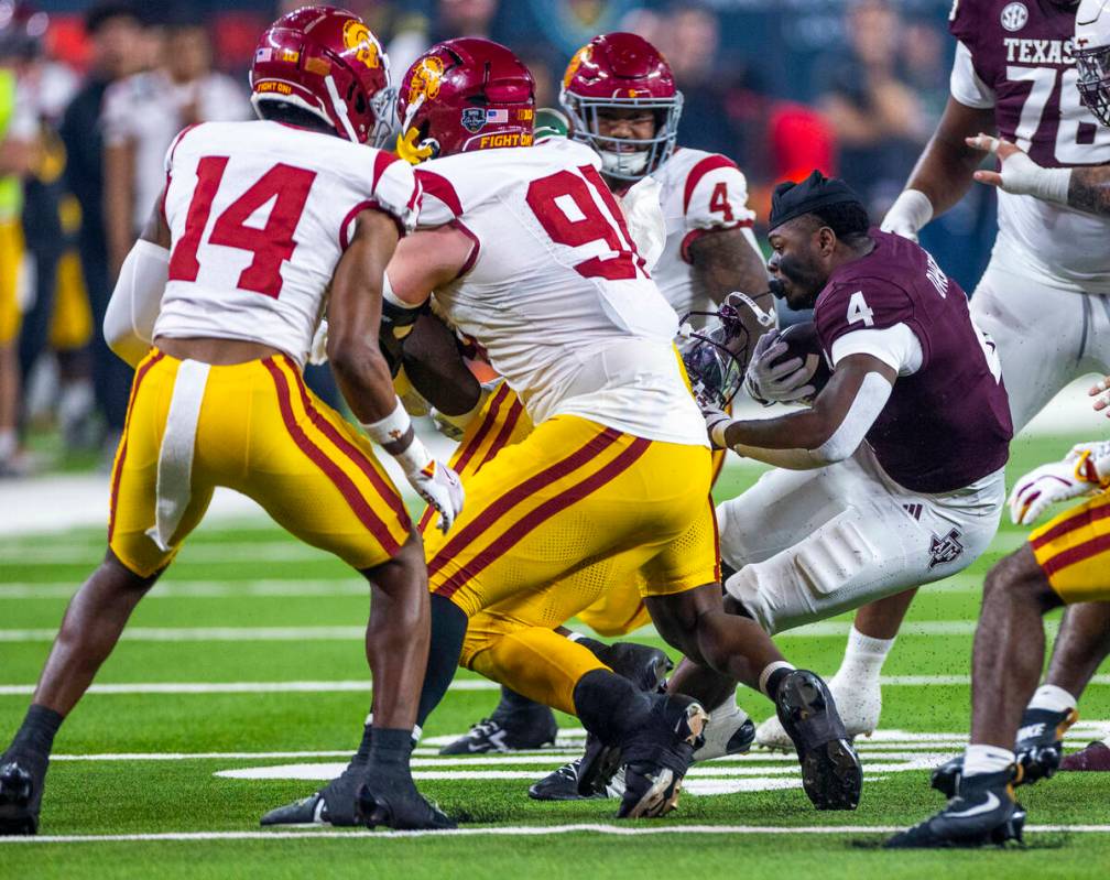 Texas A&M Aggies wide receiver Micah Tease (4) loses his helmet on a run after a hit by USC ...