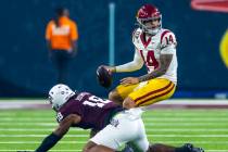 USC Trojans quarterback Jayden Maiava (14) scrambles out of a sack attempt by Texas A&M Agg ...