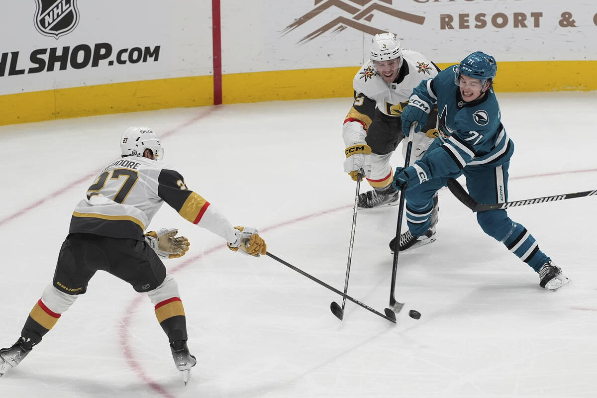 San Jose Sharks center Macklin Celebrini (71) moves the puck while being defended by Vegas Gold ...