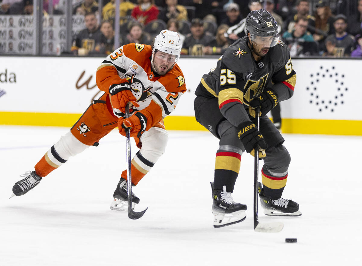 Golden Knights right wing Keegan Kolesar (55) avoids Anaheim Ducks center Mason McTavish (23) d ...