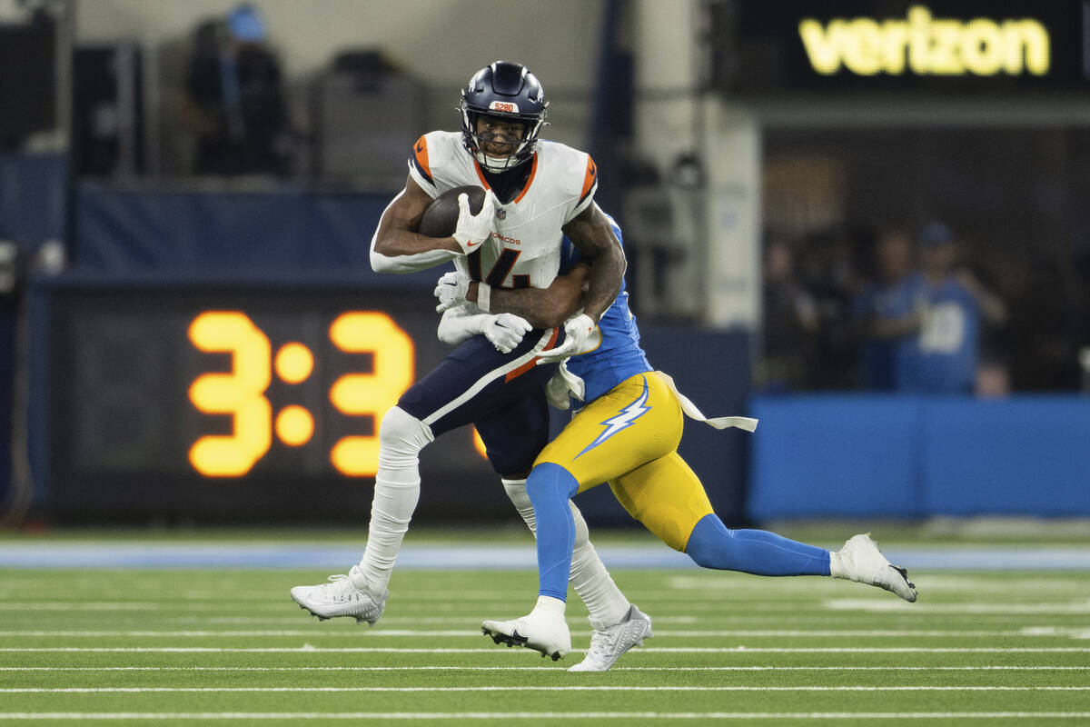 Denver Broncos wide receiver Courtland Sutton (14) runs with the ball as Los Angeles Chargers c ...