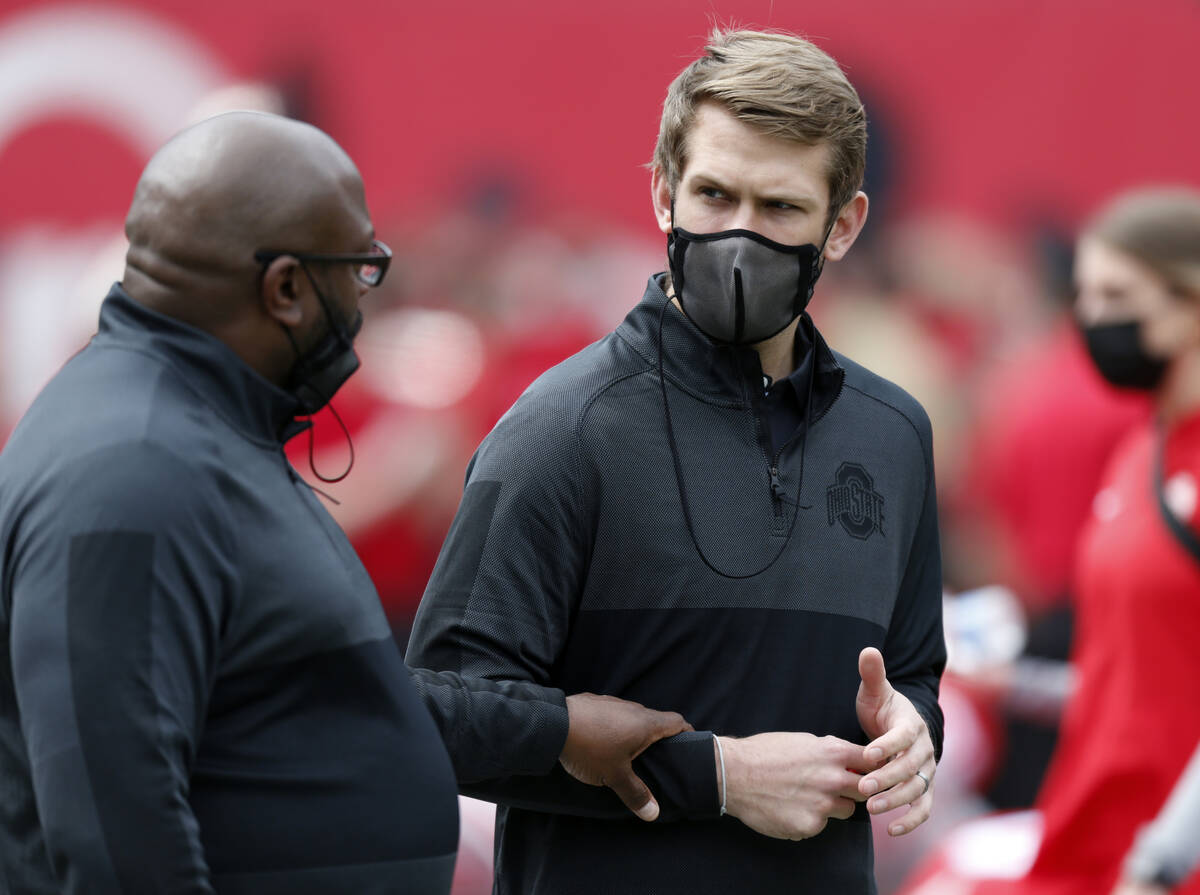 Ohio State assistant coach Tony Alford, left, talks with assistant coach Corey Dennis during wa ...