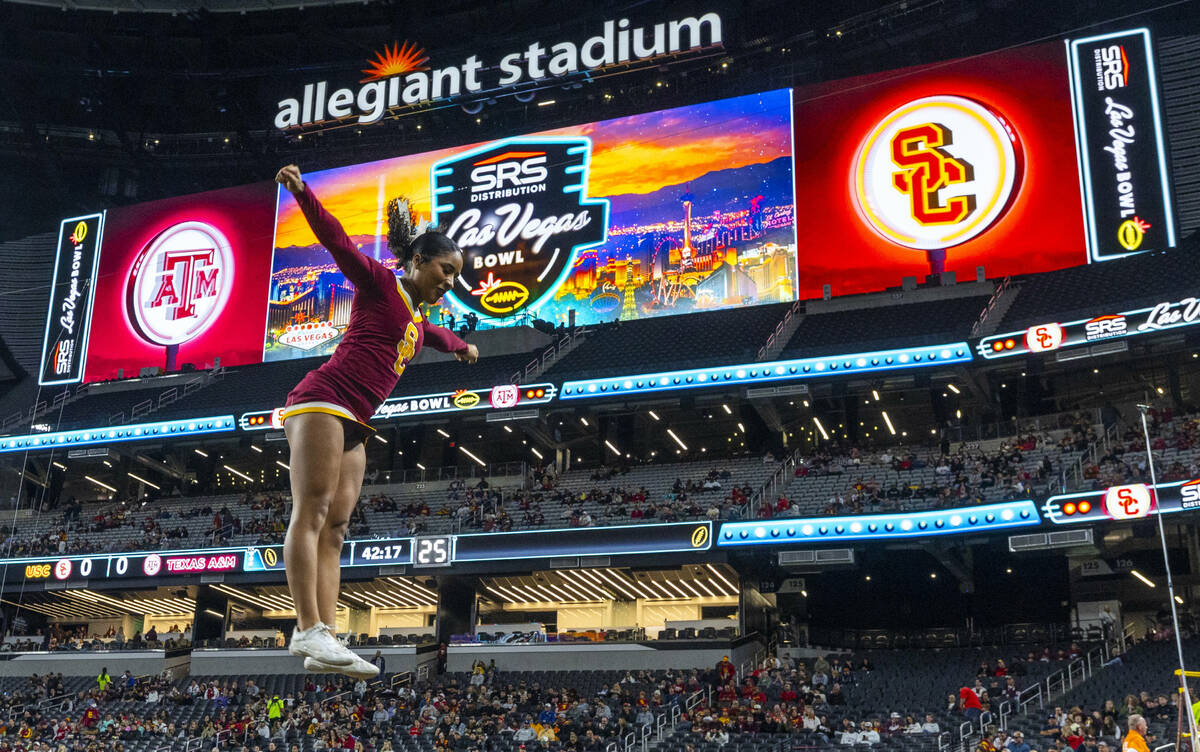 A USC Trojans cheerleader is thrown into the air as they warm up to face the Texas A&M Aggi ...