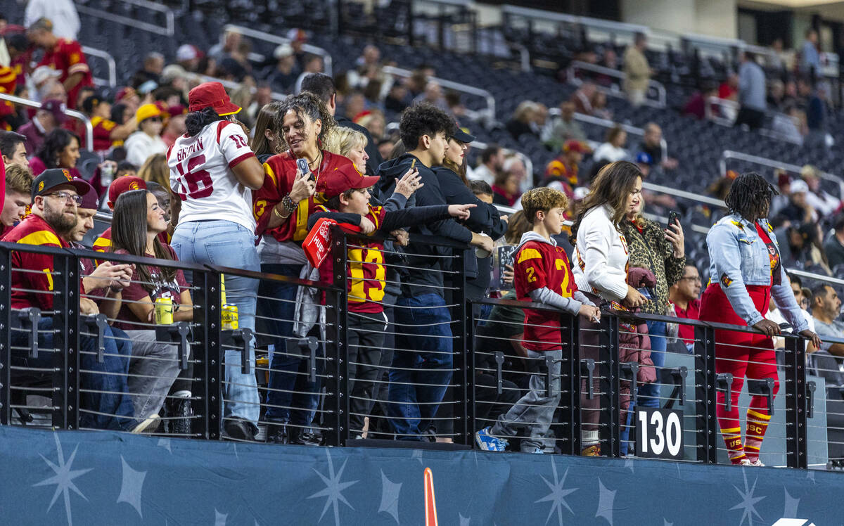 Family members look to USC Trojans players taking the field as they warm up to face the Texas A ...